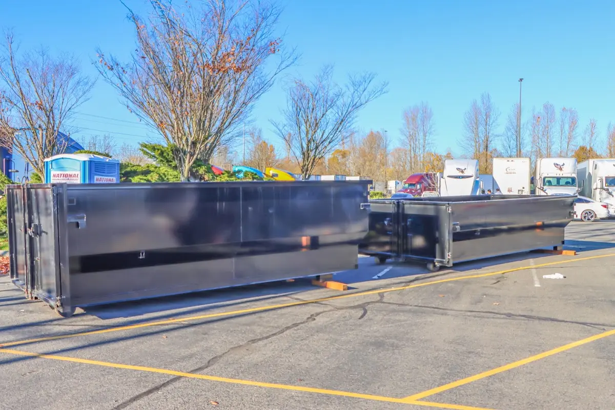 Professional dumpster rental service with roll-off container on residential driveway in Edgewood